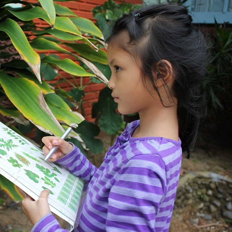 A young girl participating in a class assignment.